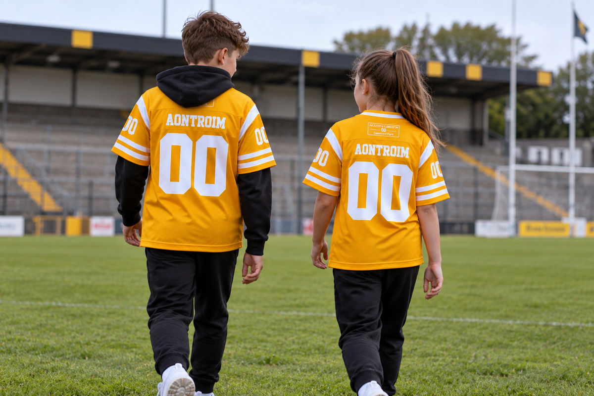 Young boy and girl wearing Aontroim Heritage Jerseys on a GAA pitch